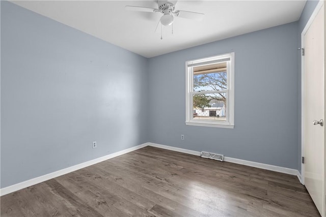 empty room with ceiling fan and dark hardwood / wood-style floors