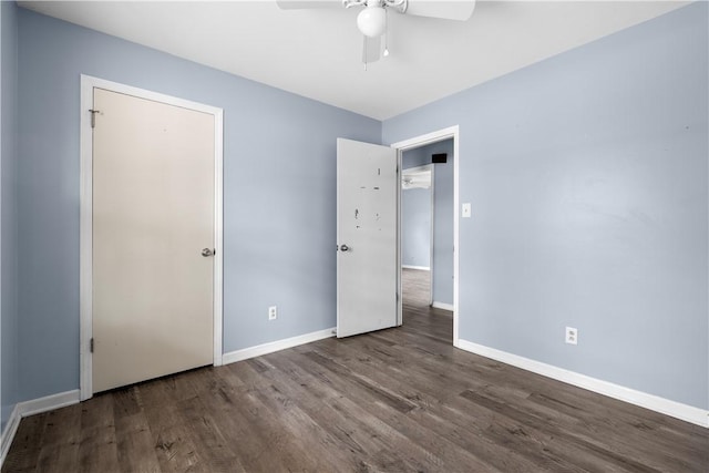 unfurnished bedroom with ceiling fan and dark hardwood / wood-style flooring