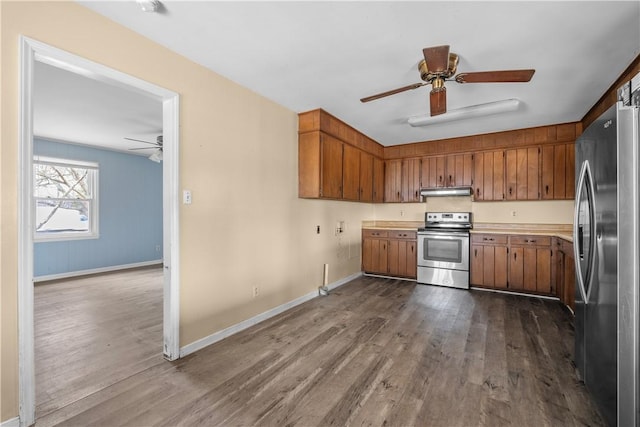 kitchen with ceiling fan, stainless steel appliances, and light hardwood / wood-style flooring