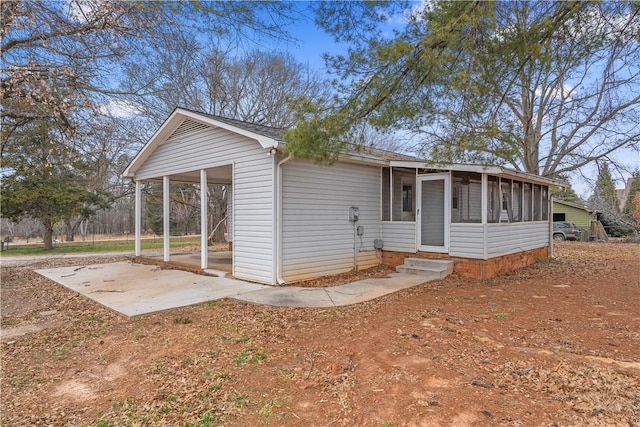 view of front of house with a patio area and a sunroom