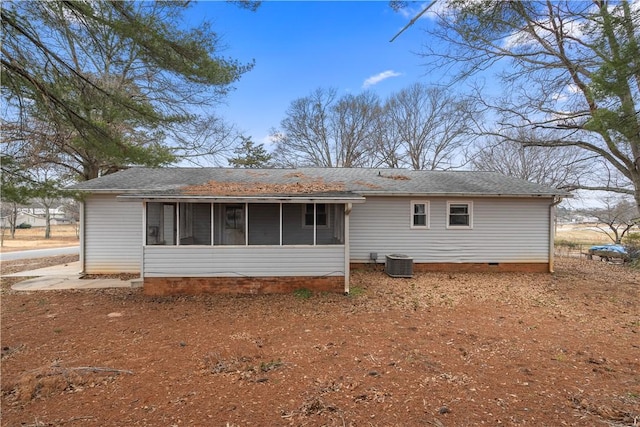 rear view of property with a sunroom and cooling unit