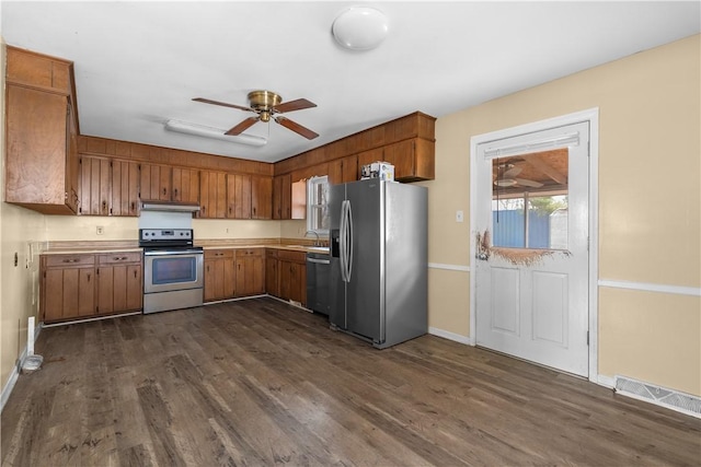 kitchen with stainless steel appliances, ceiling fan, sink, and dark hardwood / wood-style flooring