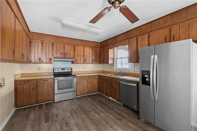 kitchen featuring stainless steel appliances, ceiling fan, sink, and dark hardwood / wood-style flooring