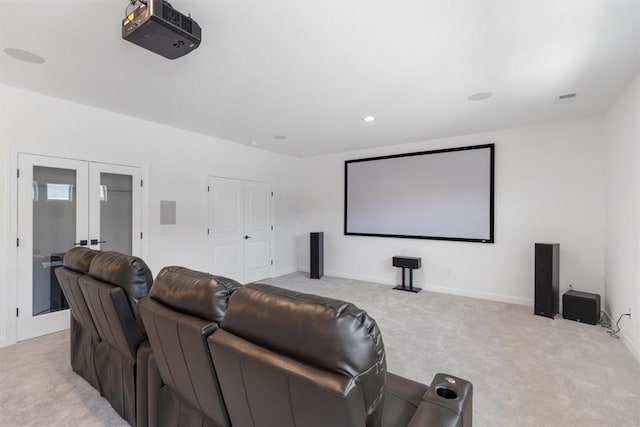 carpeted home theater room featuring french doors