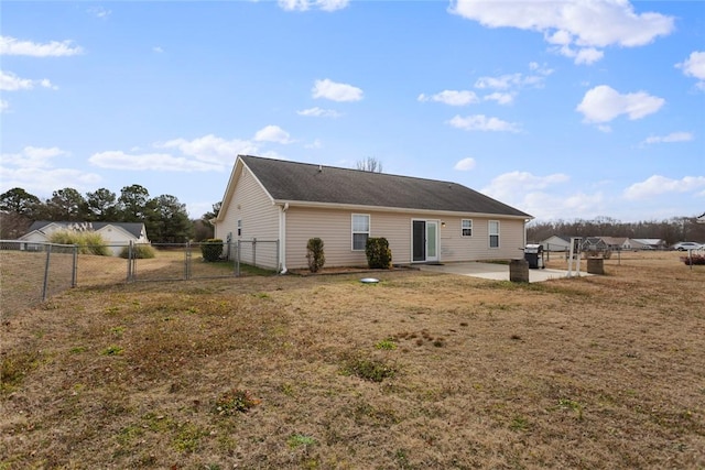 back of property featuring a yard and a patio