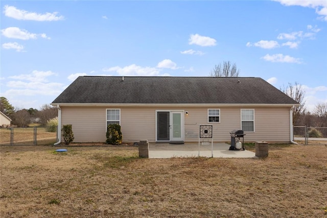 back of property featuring a patio and a yard