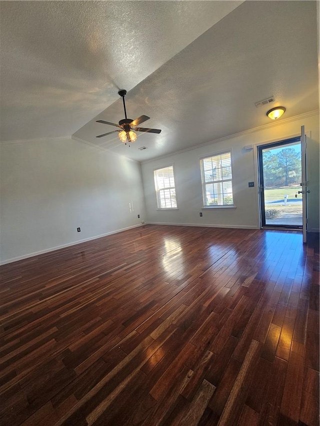 unfurnished living room featuring ceiling fan, dark wood-type flooring, and a textured ceiling