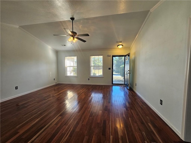 empty room with ornamental molding, dark hardwood / wood-style floors, and ceiling fan