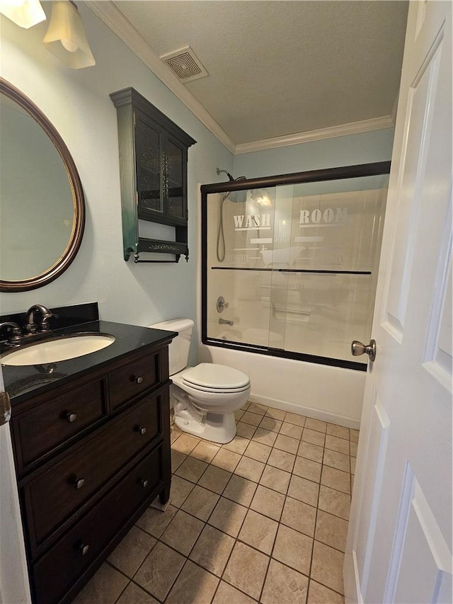 full bathroom featuring crown molding, shower / bath combination with glass door, vanity, tile patterned floors, and toilet