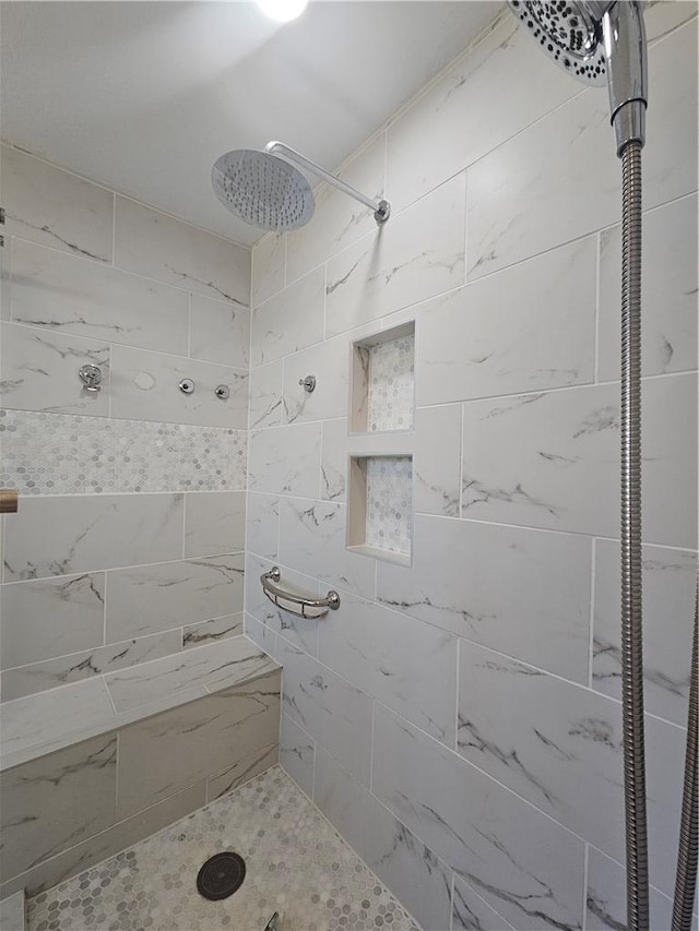 bathroom featuring a tile shower