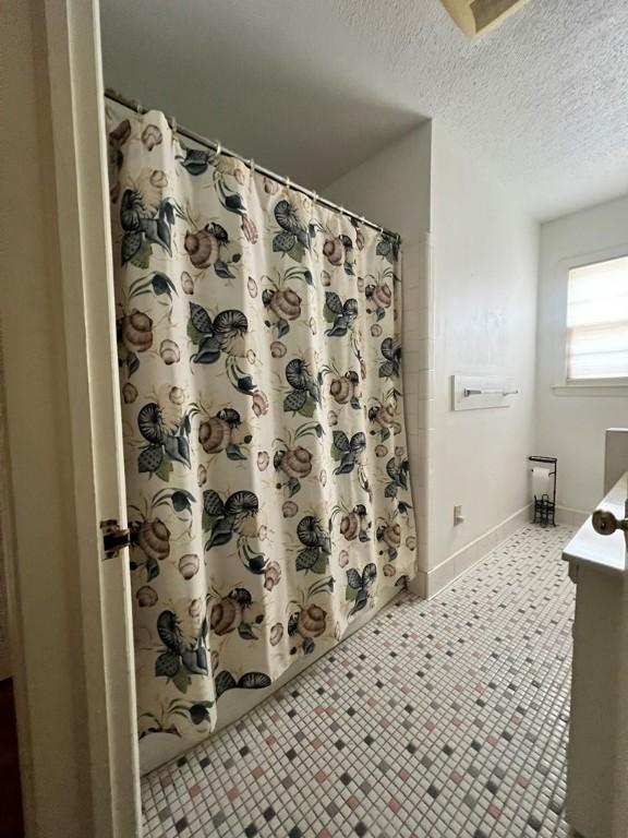 bathroom featuring vanity and a textured ceiling