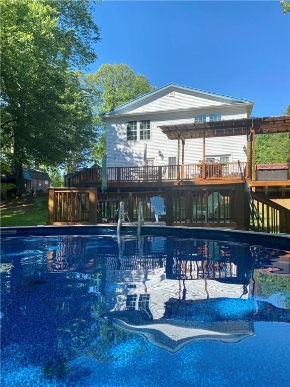 view of pool featuring a wooden deck and a pergola