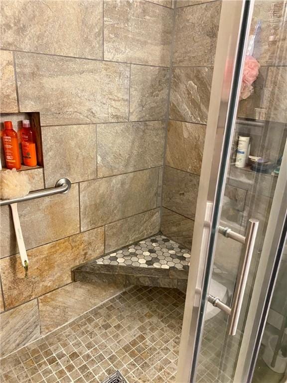 bathroom with a tile shower