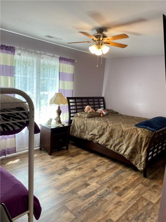 bedroom featuring hardwood / wood-style floors and ceiling fan