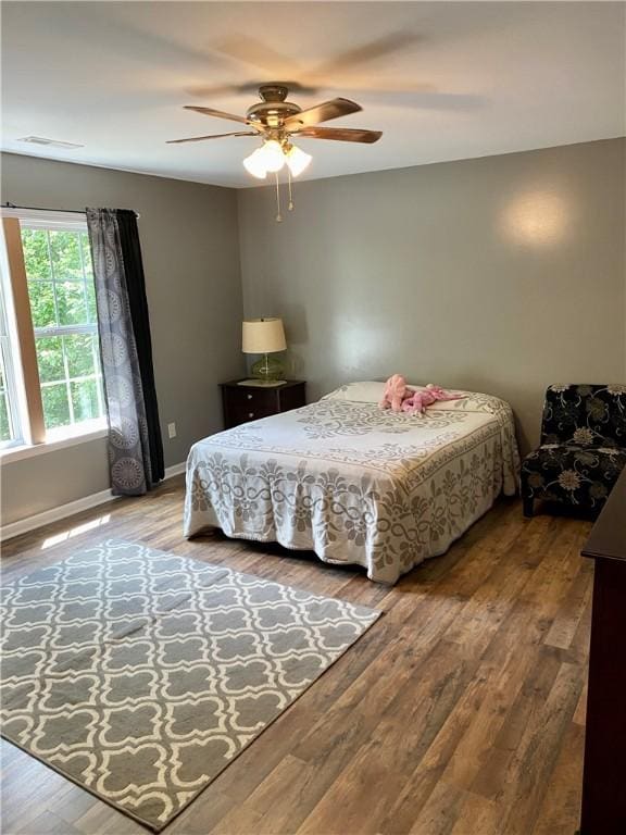 bedroom with ceiling fan and wood-type flooring