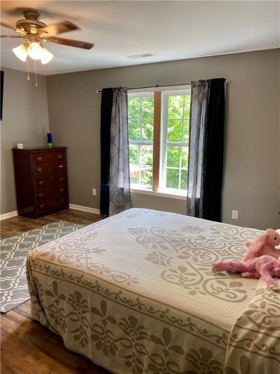 bedroom featuring hardwood / wood-style flooring and ceiling fan