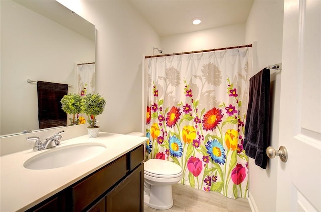 bathroom with a shower with curtain, vanity, hardwood / wood-style floors, and toilet