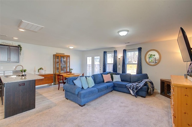 carpeted living room with sink