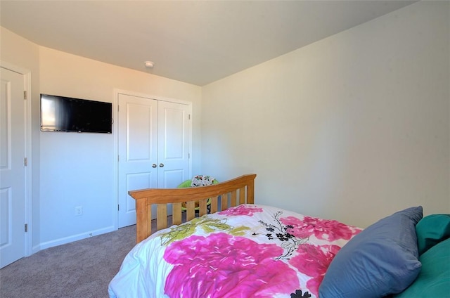 bedroom with carpet and a closet