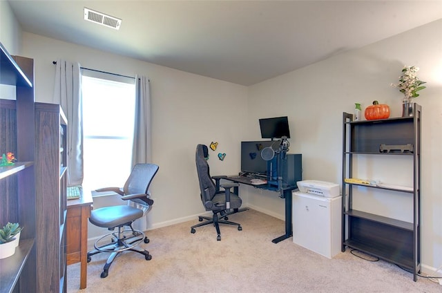 office area with plenty of natural light and light carpet