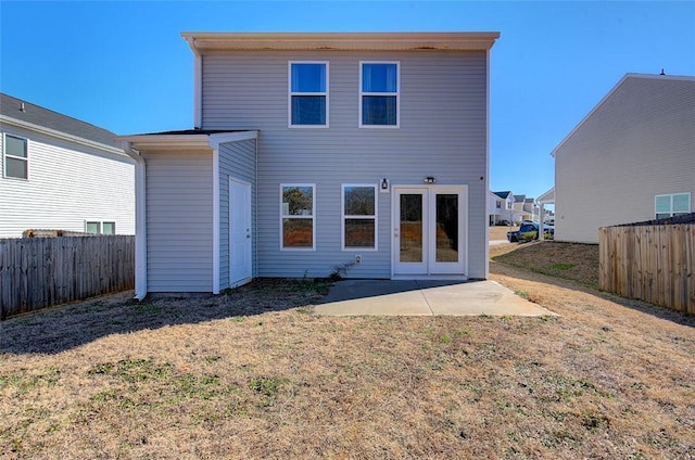 back of property with a patio area and a lawn