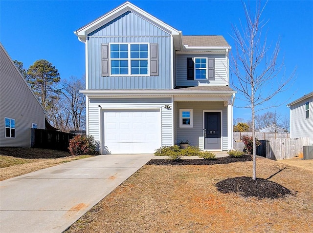 view of front of home with a garage and central AC