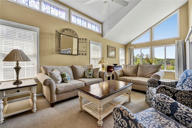 carpeted living room featuring ceiling fan and a high ceiling