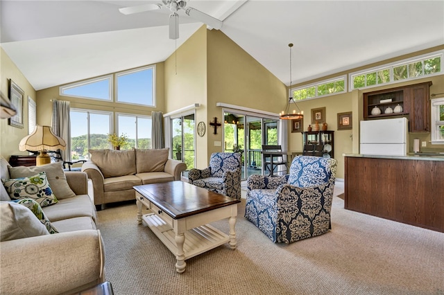 carpeted living room with high vaulted ceiling and ceiling fan