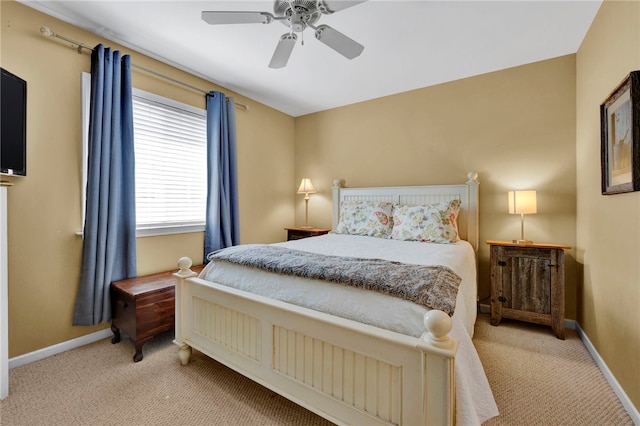 bedroom featuring ceiling fan and light carpet