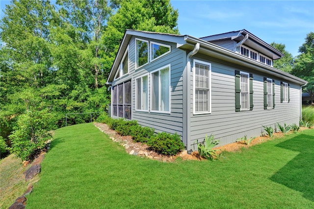 view of home's exterior with a lawn