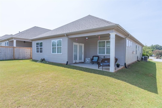 back of house featuring a yard, a patio area, and central AC