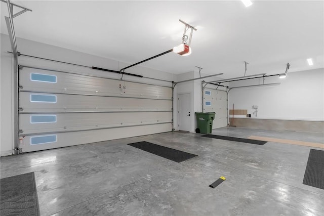 garage with a garage door opener and a carport