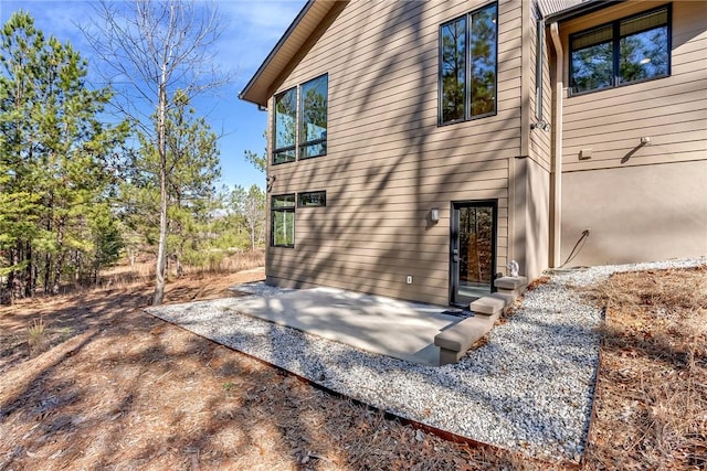 rear view of property featuring a patio