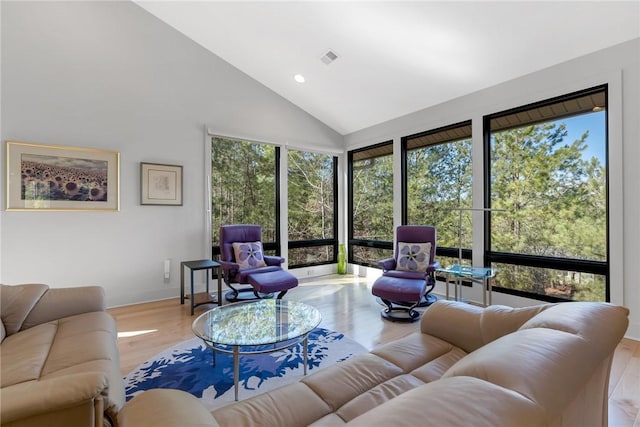 living room featuring light hardwood / wood-style flooring and high vaulted ceiling