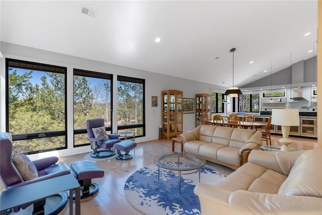 living room with lofted ceiling and light hardwood / wood-style floors