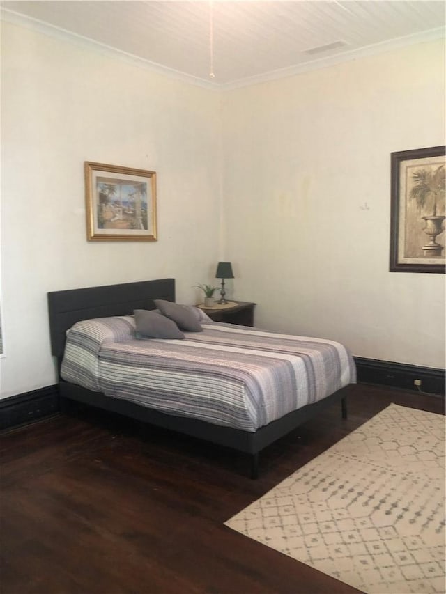 bedroom featuring ornamental molding and dark hardwood / wood-style floors