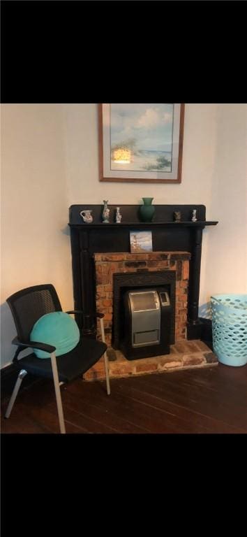 living area featuring wood-type flooring and a fireplace