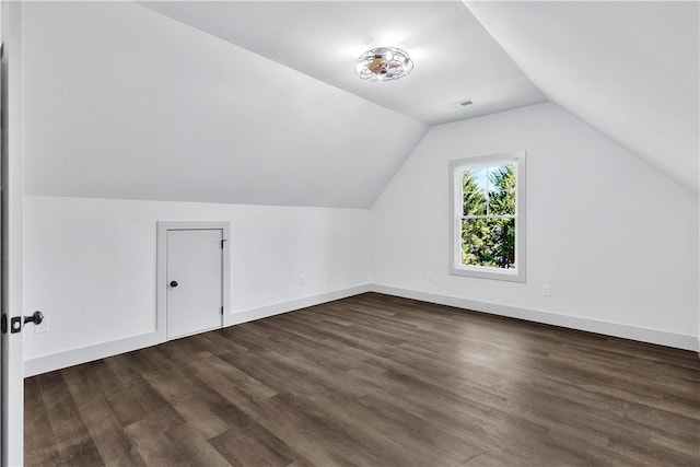 bonus room with vaulted ceiling and dark hardwood / wood-style floors