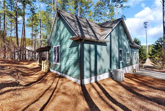 view of side of home with central air condition unit