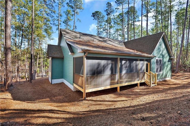 view of side of home with a sunroom