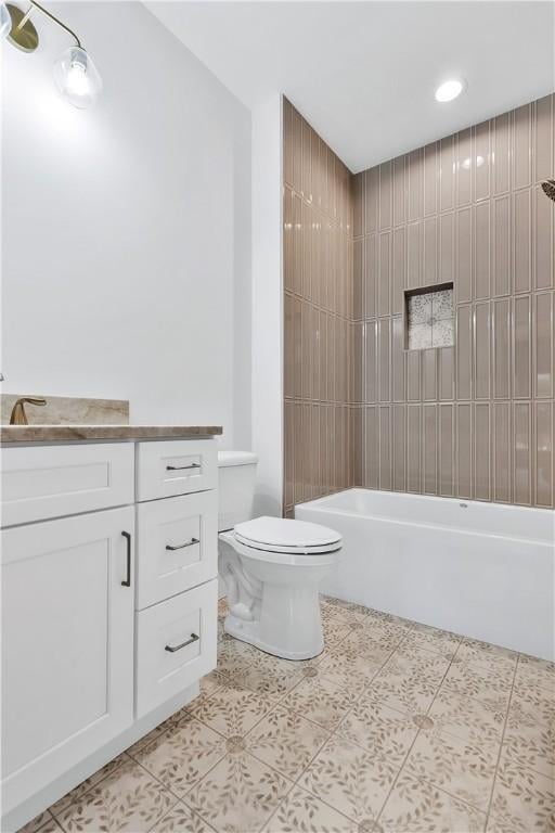 full bathroom featuring tiled shower / bath combo, vanity, tile patterned flooring, and toilet