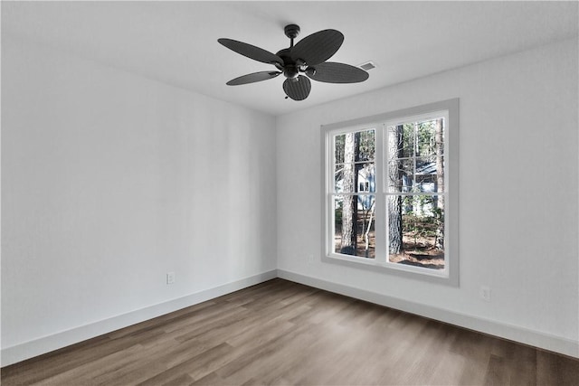 spare room featuring wood-type flooring and ceiling fan