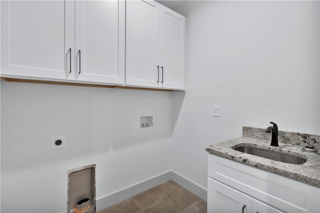 clothes washing area with cabinets, washer hookup, hookup for an electric dryer, and sink