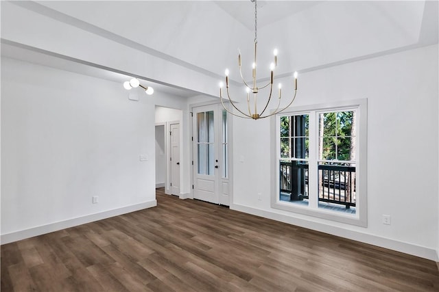 unfurnished dining area with wood-type flooring, vaulted ceiling, and a notable chandelier