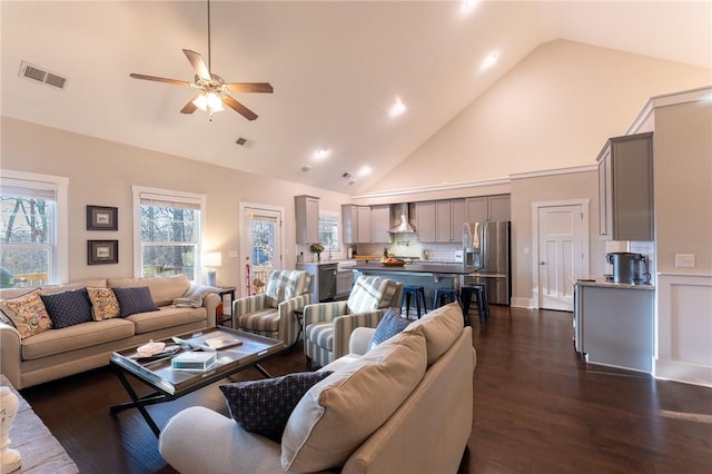 living room featuring high vaulted ceiling, dark hardwood / wood-style floors, and ceiling fan