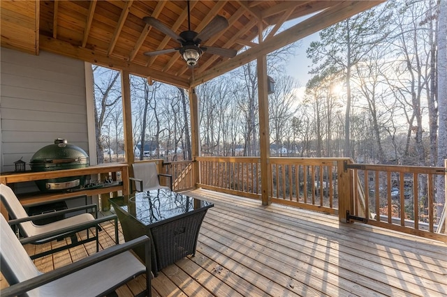 deck featuring area for grilling and ceiling fan