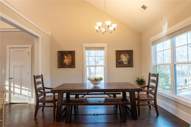 dining space featuring lofted ceiling, an inviting chandelier, and dark hardwood / wood-style flooring