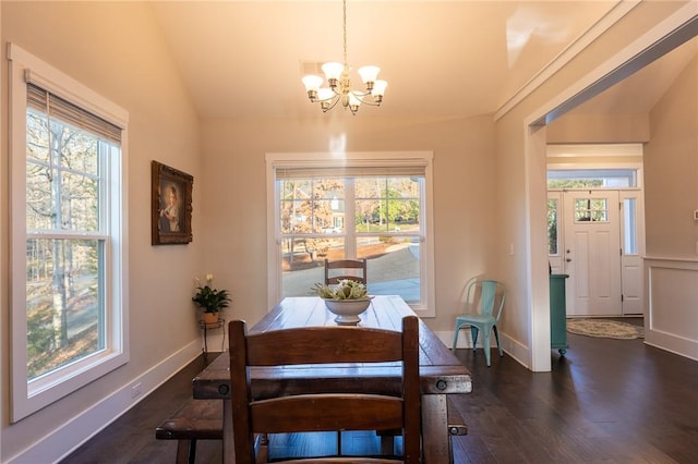 dining space featuring an inviting chandelier, dark hardwood / wood-style flooring, and vaulted ceiling