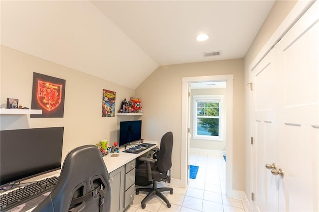 office space featuring lofted ceiling and light tile patterned floors