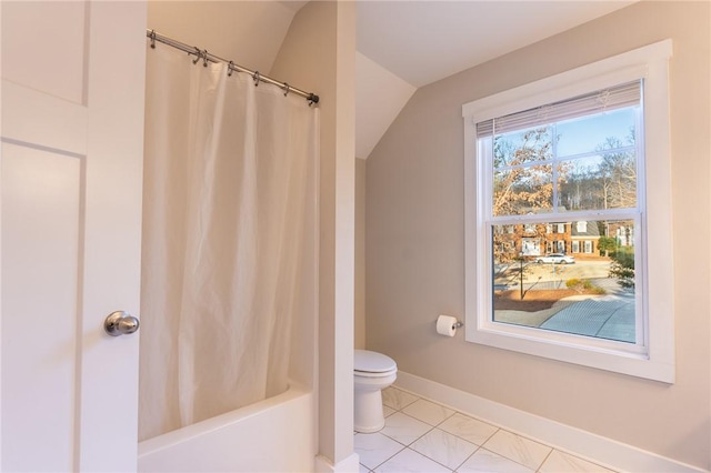 bathroom featuring lofted ceiling, tile patterned floors, toilet, and shower / tub combo with curtain